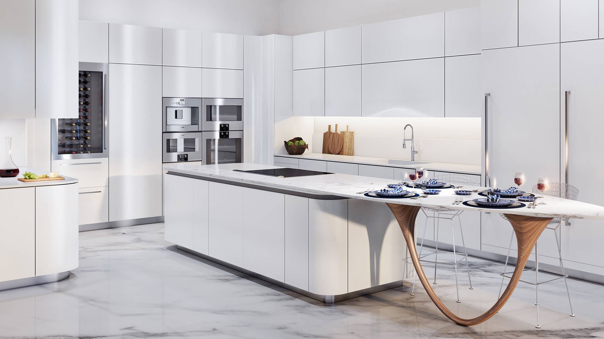 Jade Signature in Sunny Isles Beach luxury and ultra luxury condos chef kitchen with white cabinetry, built in appliances, a large marble island and minimalist modern finishes.
