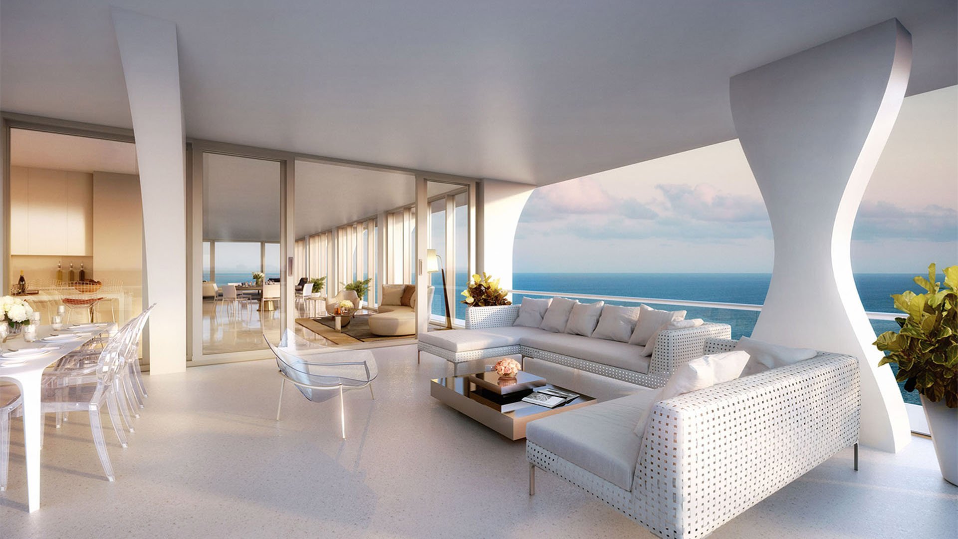 Jade Signature in Sunny Isles Beach luxury and ultra luxury condos open concept living and dining room with sculptural columns, woven seating and an ocean balcony at soft evening light.
