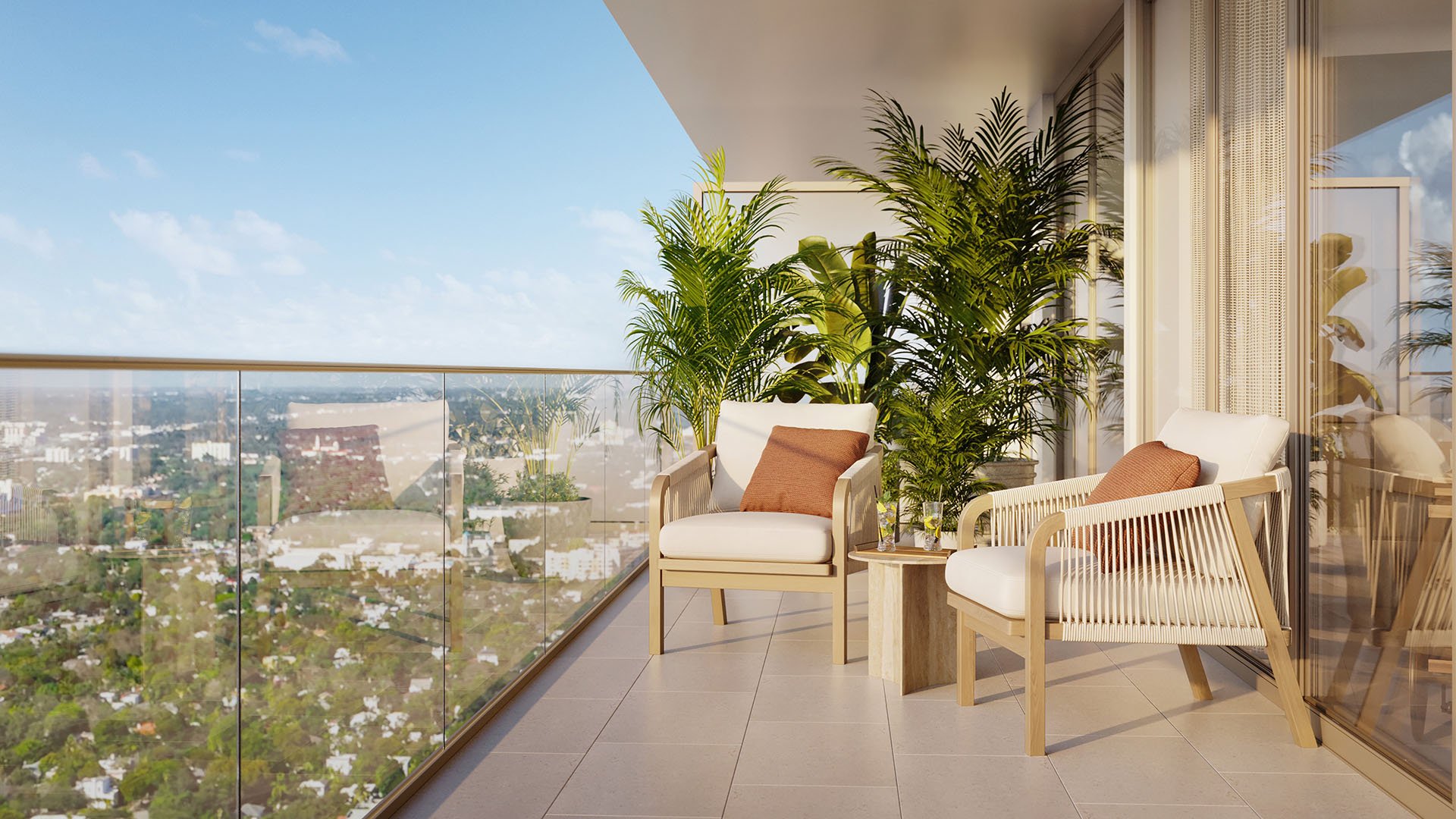 Jean-Georges Miami Tropic Residences balcony with two lounge chairs, tropical plants and glass railing overlooking Miami city views, Miami, Florida, showcasing luxury and ultra luxury preconstruction condos with resort-style outdoor living.