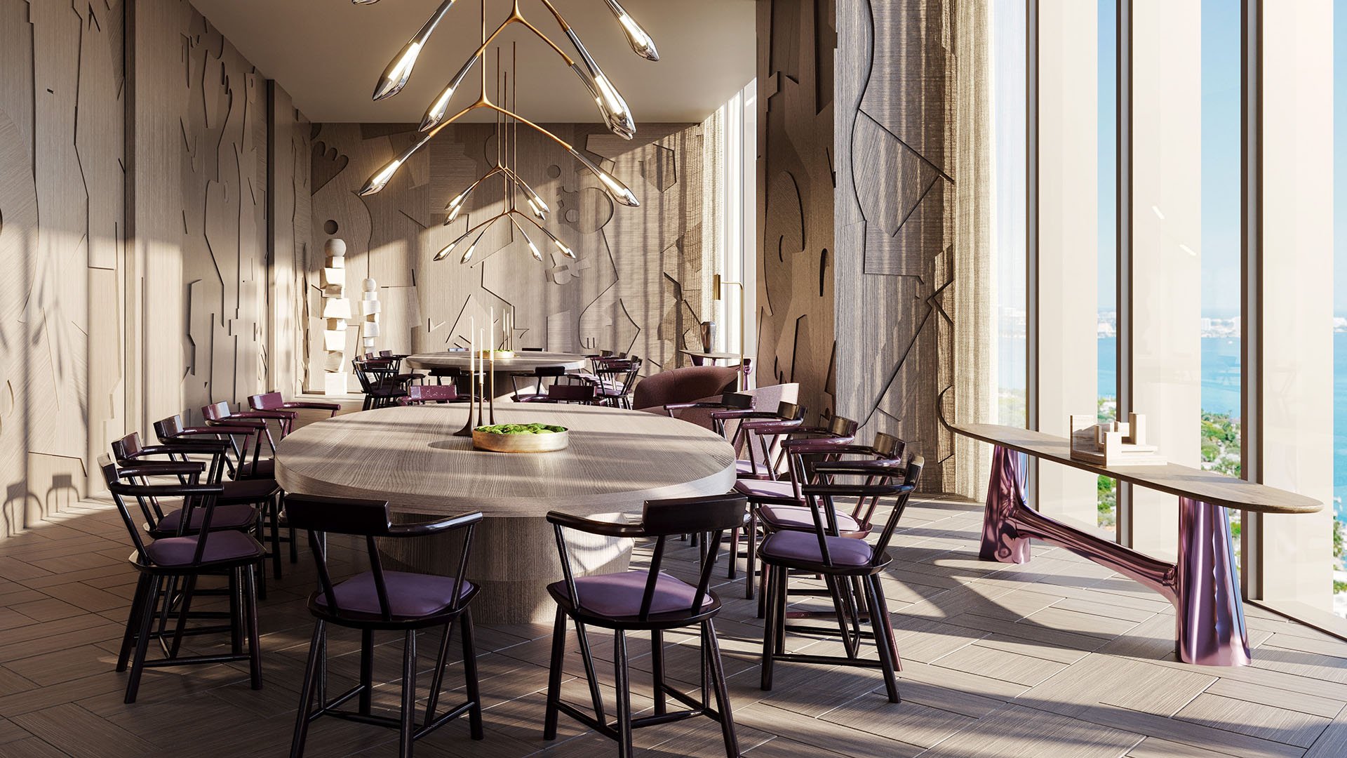 Jean-Georges Miami Tropic Residences private dining room with oval table, purple chairs and sculptural chandelier overlooking the water, Miami, Florida, highlighting luxury and ultra luxury preconstruction condos with exclusive entertaining spaces.