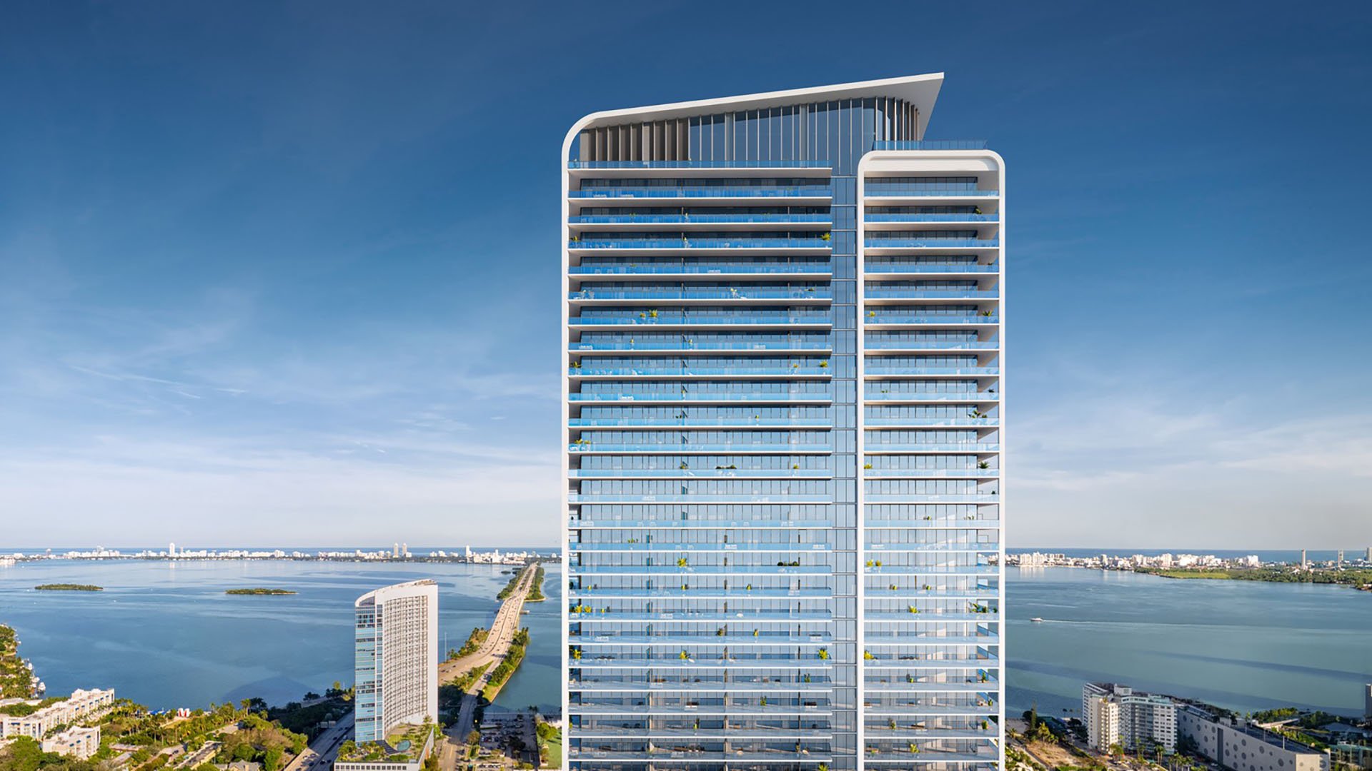Aerial view of Jean-Georges Miami Tropic Residences modern glass condo tower on Biscayne Bay, Miami, Florida, showcasing luxury and ultra luxury preconstruction condos with panoramic waterfront skyline setting.