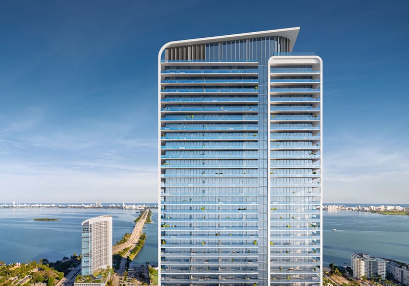 Aerial view of Jean-Georges Miami Tropic Residences modern glass condo tower on Biscayne Bay, Miami, Florida, showcasing luxury and ultra luxury preconstruction condos with panoramic waterfront skyline setting.