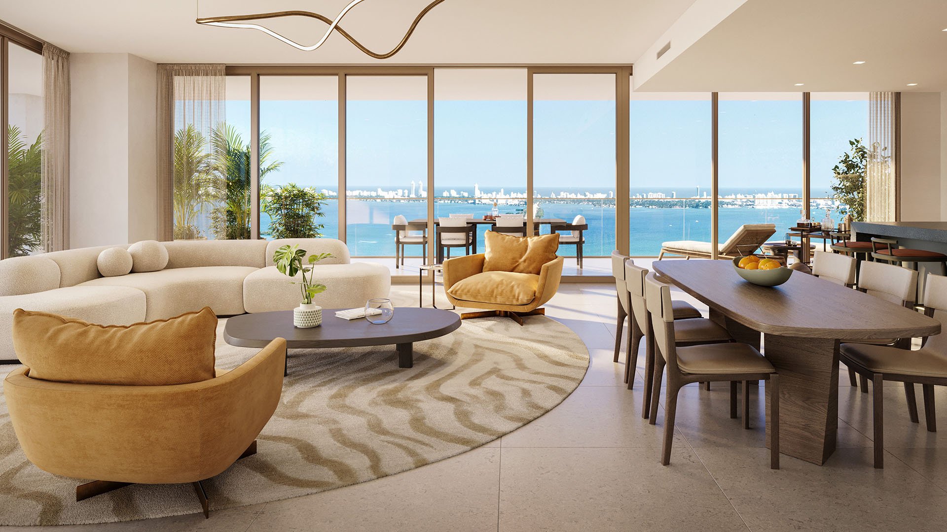 Open-plan living and dining at Jean-Georges Miami Tropic Residences overlooking Biscayne Bay, Miami, Florida, with floor-to-ceiling glass and terrace seating, highlighting luxury and ultra luxury preconstruction condos with ocean views.