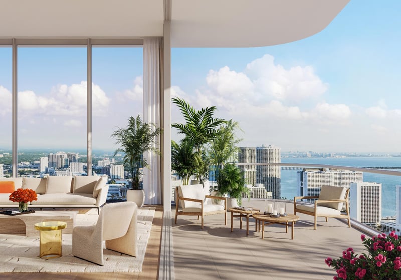 JEM Residences, Miami Worldcenter, Miami, luxury and ultra luxury condos with a bright open living room, floor-to-ceiling glass, wraparound terrace seating, and expansive bay and skyline views.