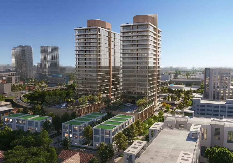 Kempinski Residences Miami in Miami Design District, luxury and ultra luxury condos, preconstruction aerial neighborhood view of twin towers rising above surrounding low-rise blocks with landscaped amenity decks and the city skyline in the distance.