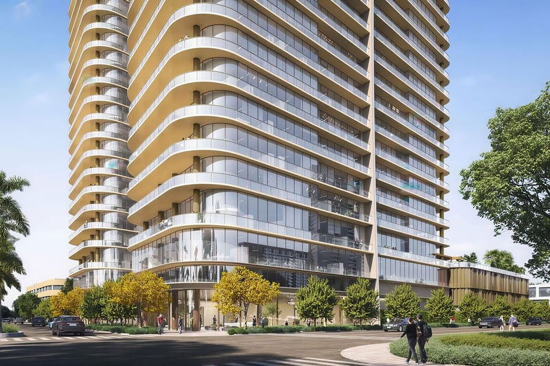 Kempinski Residences Miami in Miami Design District, luxury and ultra luxury condos, preconstruction street-corner exterior highlighting curved glass facades, wraparound balconies, double-height lobby glazing, and landscaped sidewalks.