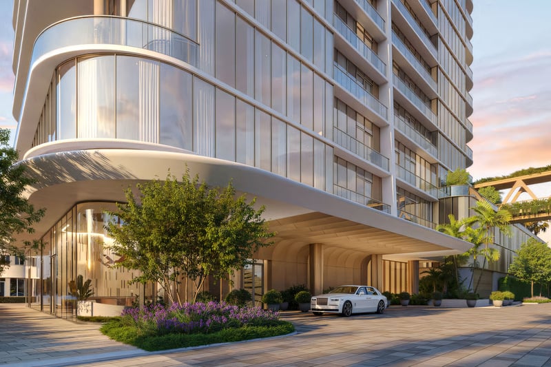 Kempinski Residences Miami in Miami Design District, luxury and ultra luxury condos, preconstruction arrival scene with a sweeping porte cochere, glass lobby, landscaped entry, and an elevated garden bridge beside the tower.