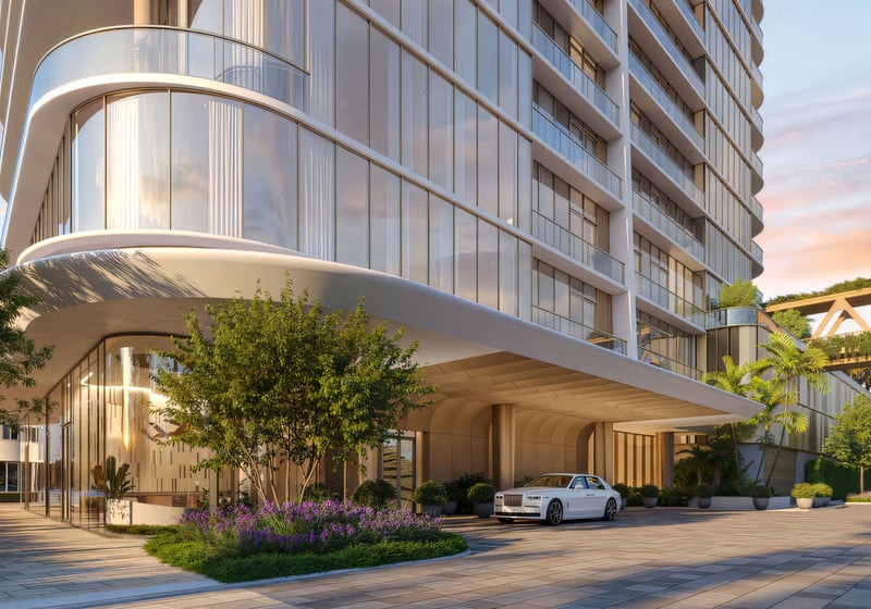 Kempinski Residences Miami in Miami Design District, luxury and ultra luxury condos, preconstruction arrival scene with a sweeping porte cochere, glass lobby, landscaped entry, and an elevated garden bridge beside the tower.