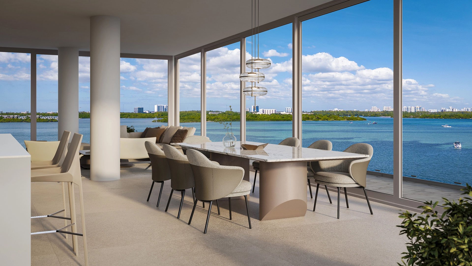 La Mare Bay Tower dining room in Bay Harbor Islands, Miami, Florida, with corner windows, marble table and expansive waterfront bay view, highlighting luxury and ultra luxury preconstruction condos living.