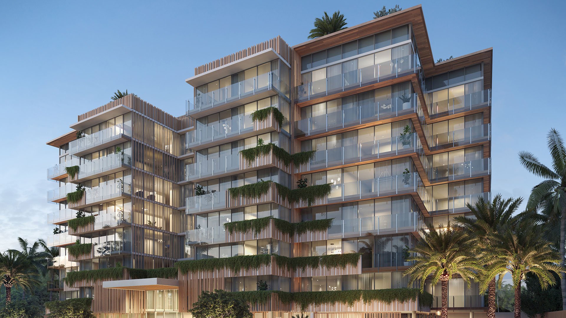 La Mare Regency Tower exterior at dusk in Bay Harbor Islands, Miami, Florida, with glass balconies and landscaped terraces, showcasing luxury and ultra luxury preconstruction condos architecture.
