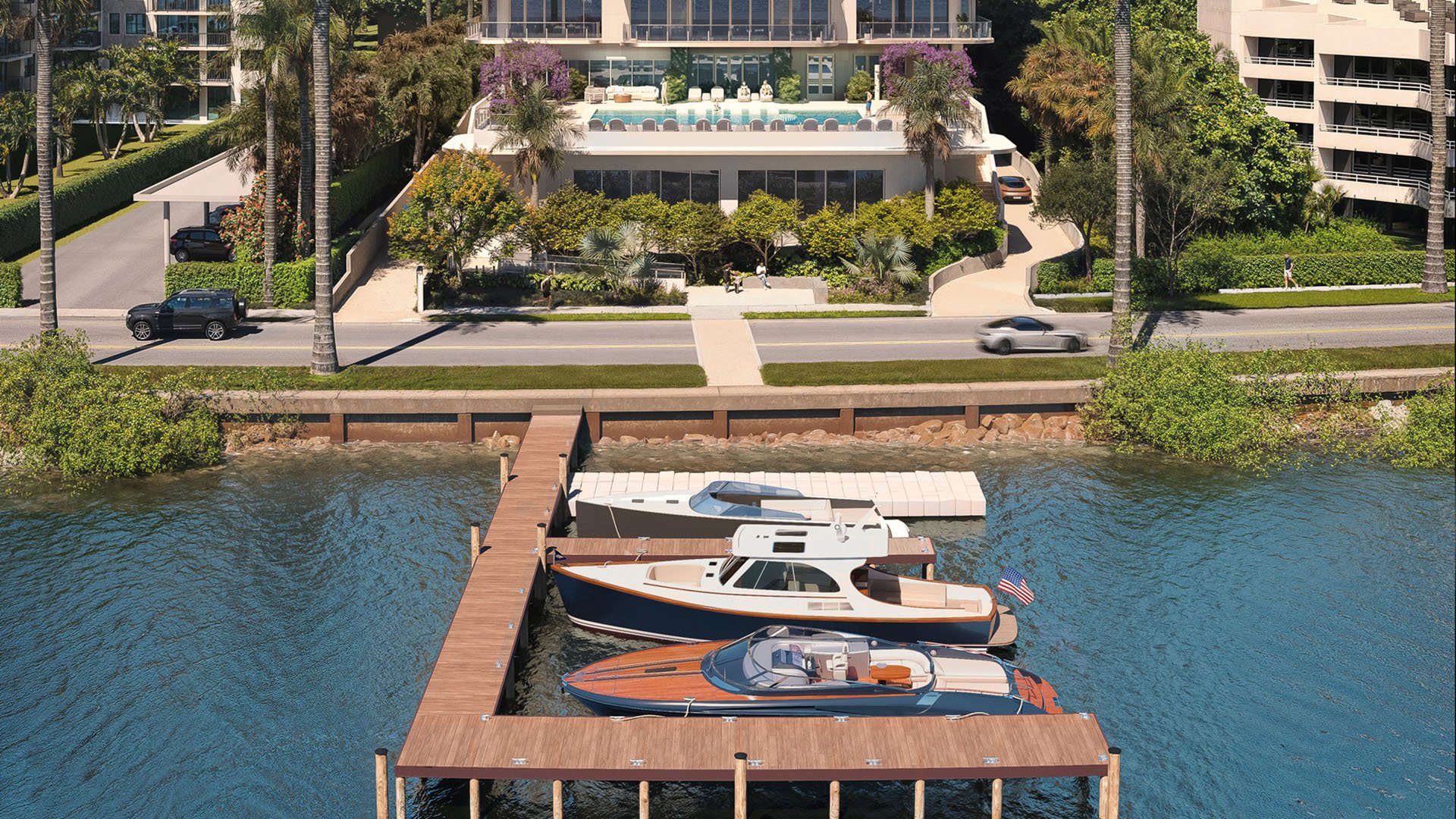 Aerial view of a private dock with boats, waterfront edge and pool deck at Maison D'Or in West Palm Beach, showcasing luxury and ultra luxury preconstruction condos with direct boating access.