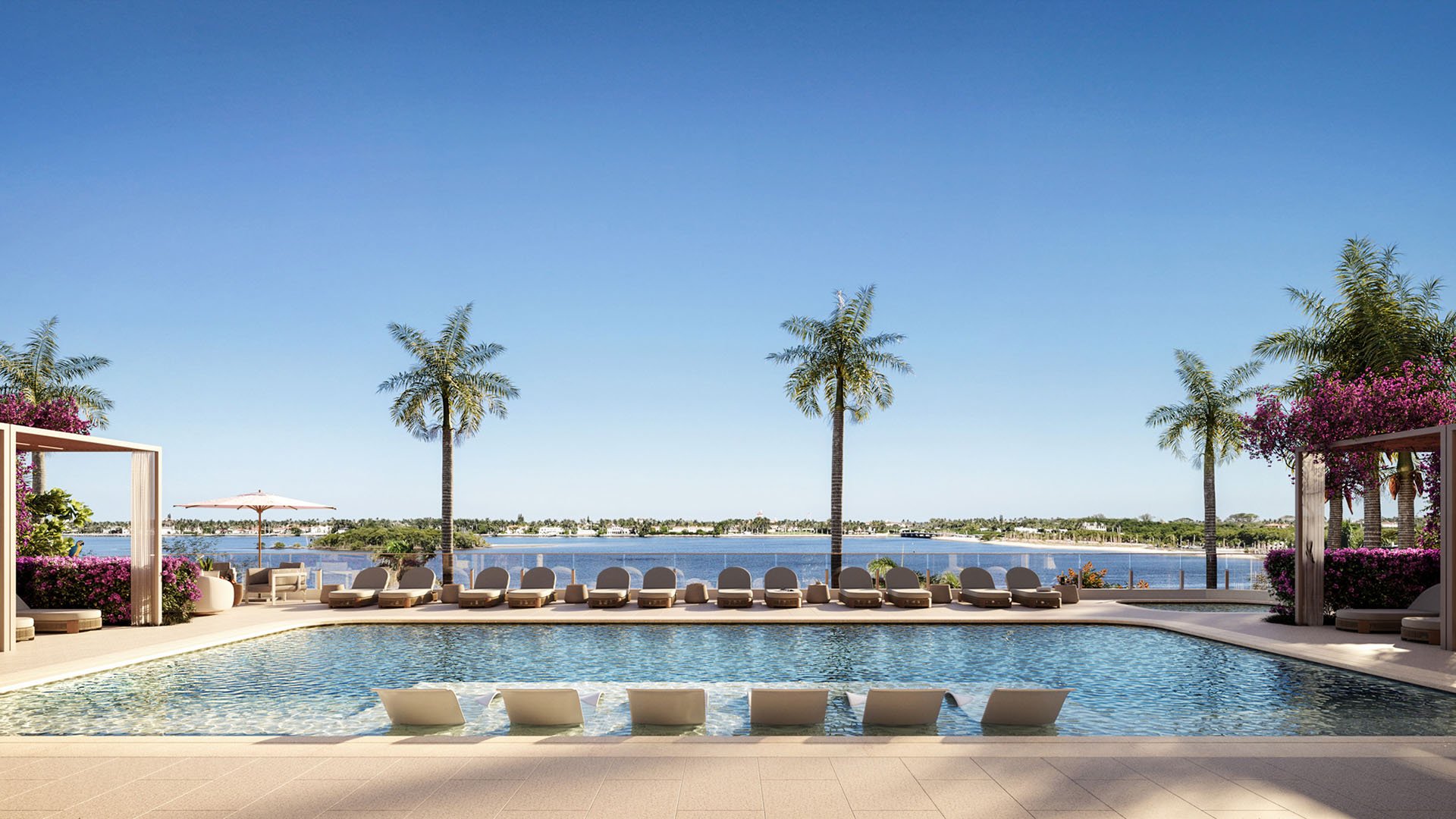 Daytime waterfront pool terrace with submerged loungers, palm trees and pergolas at Maison D'Or in West Palm Beach, showcasing luxury and ultra luxury preconstruction condos beside the water.