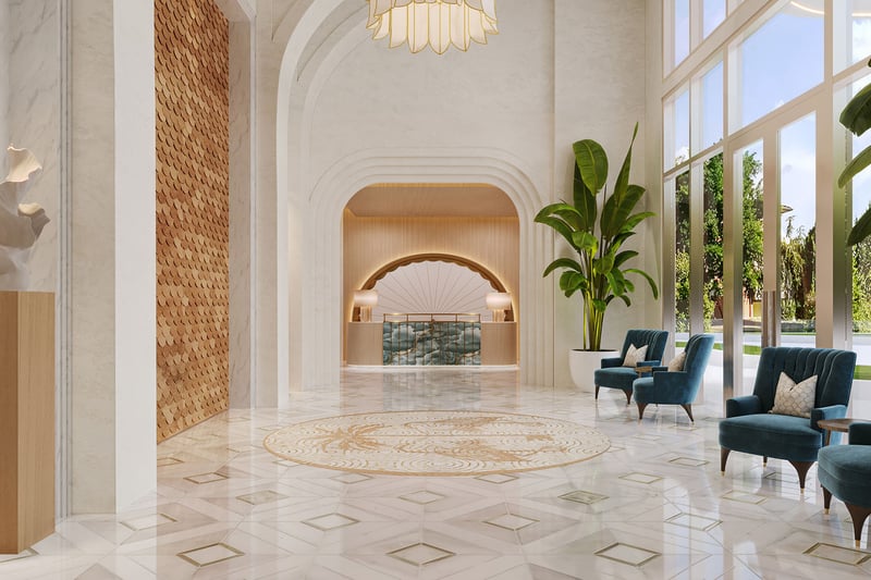 Double-height marble lobby with arched detailing, tall windows and lounge seating at Maison D'Or in West Palm Beach, reflecting luxury and ultra luxury preconstruction condos with refined arrival design.