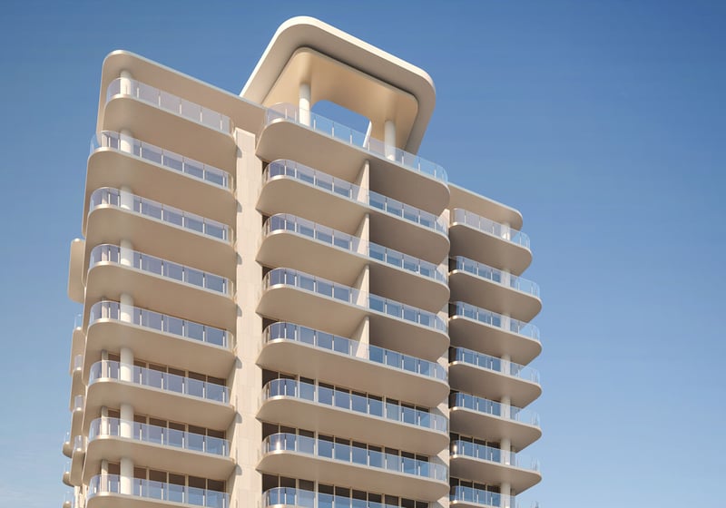 Angled view of the rounded balcony tower rising against a clear blue sky at Maison D'Or in West Palm Beach, featuring luxury and ultra luxury preconstruction condos with sculpted exterior lines.