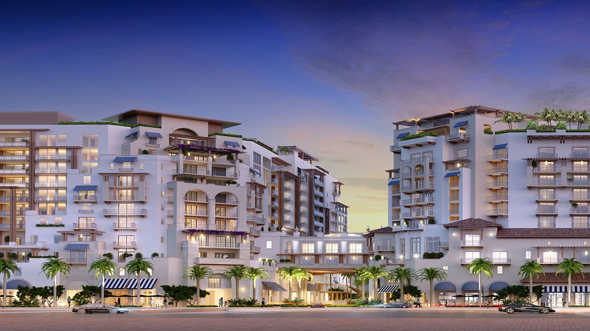 Mandarin Oriental Residences Boca Raton, Florida twilight street view of illuminated entry and palm-lined promenade, promoting luxury and ultra luxury preconstruction condos with refined curb appeal and mixed-use amenities.