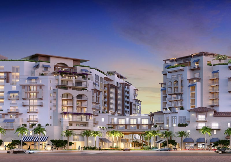 Mandarin Oriental Residences Boca Raton, Florida twilight street view of illuminated entry and palm-lined promenade, promoting luxury and ultra luxury preconstruction condos with refined curb appeal and mixed-use amenities.