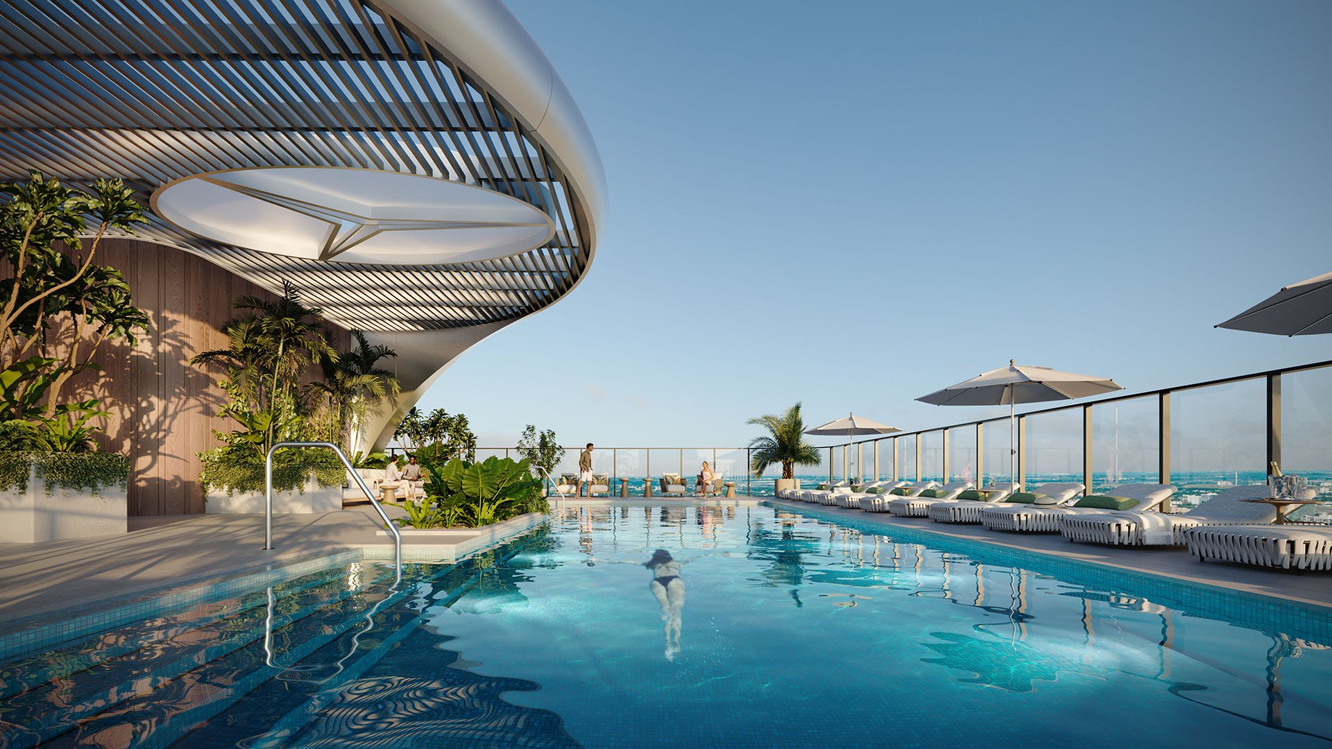 Mercedes-Benz Places Miami rooftop pool deck in Miami, Florida with infinity lap pool, curved canopy, loungers and umbrellas overlooking the skyline and ocean, elevating luxury and ultra luxury preconstruction condos amenities.