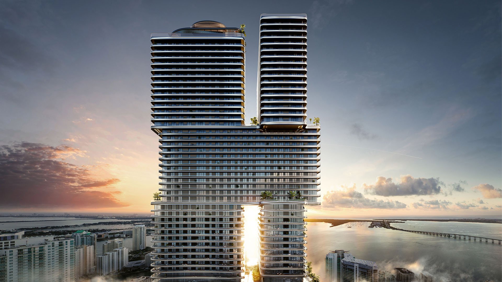 Mercedes-Benz Places Miami hero exterior in Miami, Florida showing twin residential towers with skybridge at sunset over the waterfront, iconic luxury and ultra luxury preconstruction condos architecture.