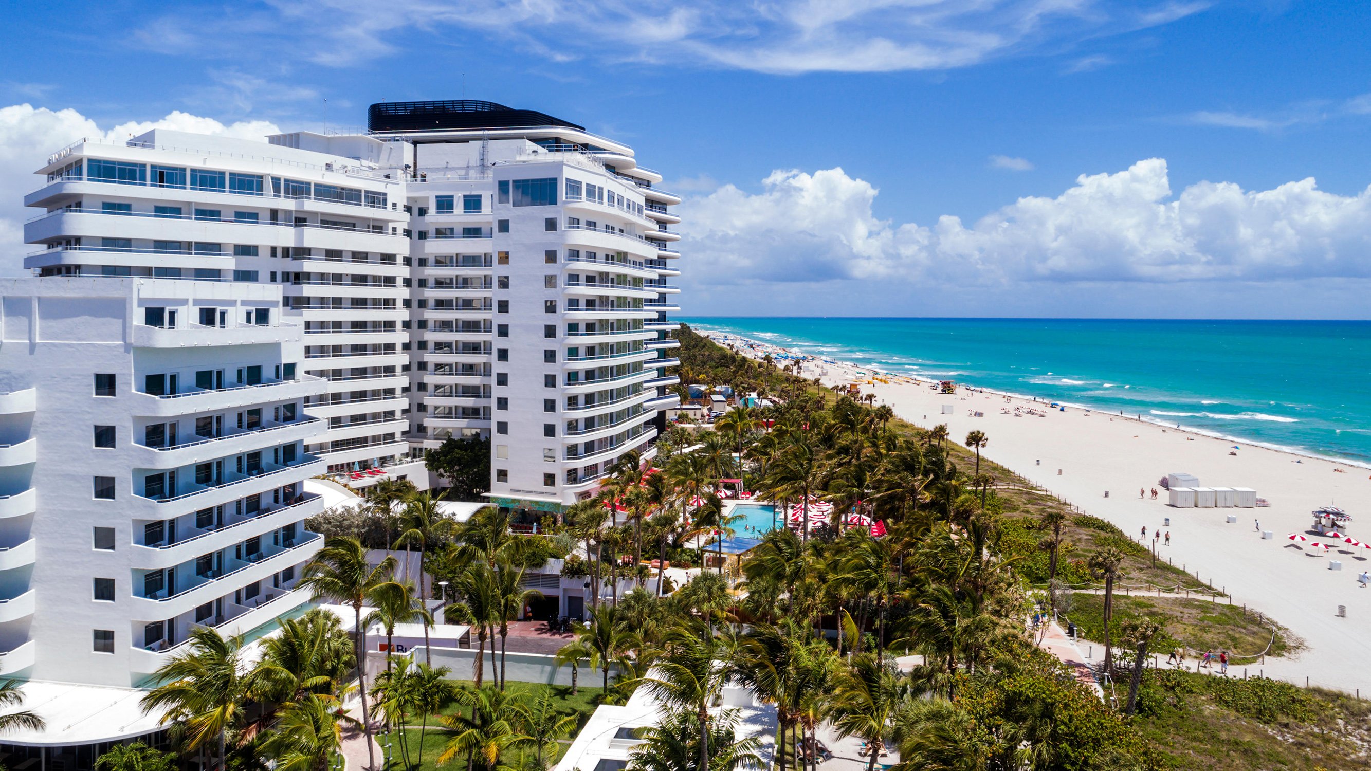 Miami Beach beachfront resort view, pools, dunes and turquoise ocean; premier destination for luxury and ultra luxury condos, offering preconstruction and resale.