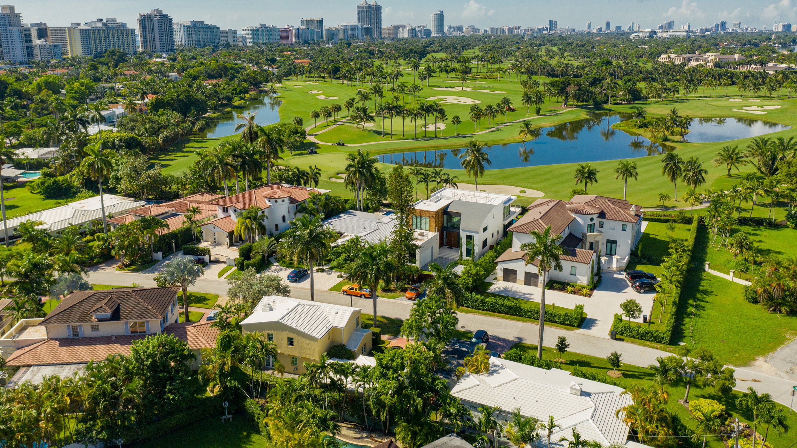 Miami Beach luxury homes overlooking golf course and lakes - exclusive neighborhoods alongside luxury and ultra luxury condos; active resale market.