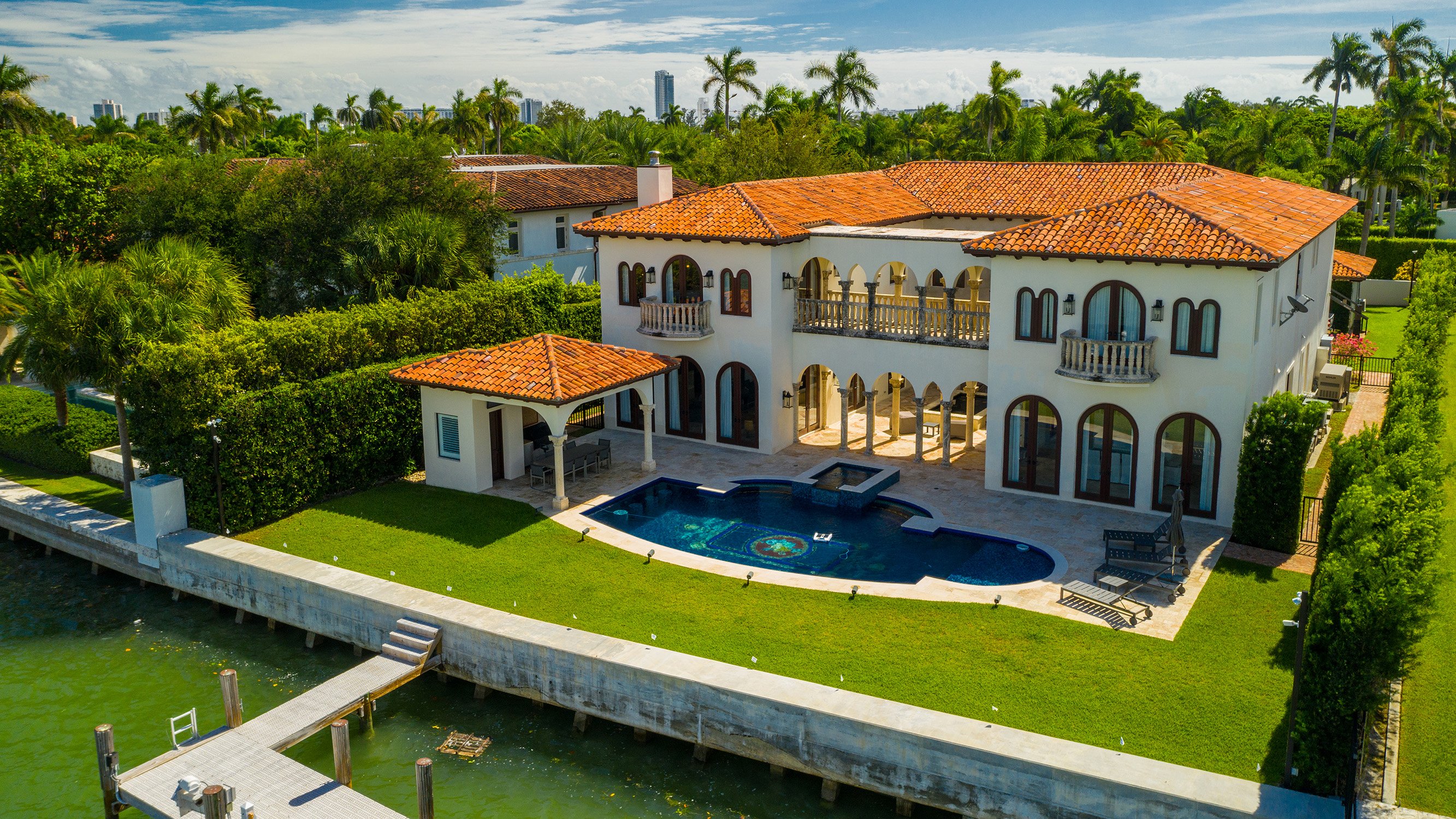 Miami Beach luxury waterfront house with pool and modern architecture—prestigious surroundings near luxury and ultra luxury condos; resale.