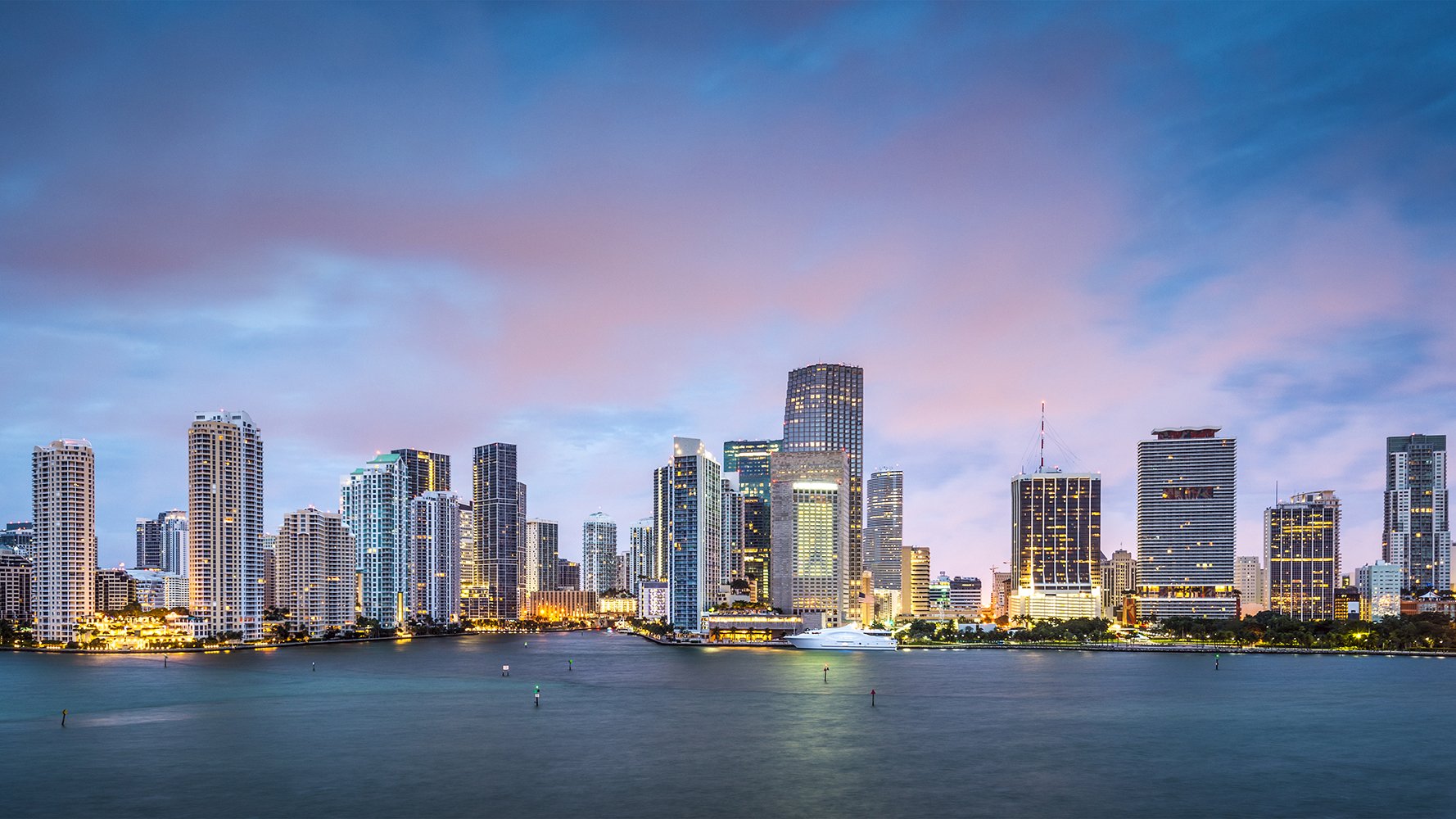 Miami skyline night view, lights over Biscayne Bay—Downtown Miami, Florida; iconic hub for luxury and ultra luxury condos; active preconstruction and resale.