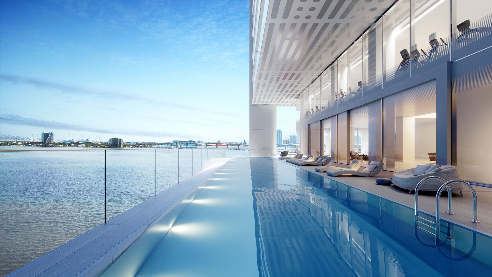 Missoni Baia Edgewater Miami waterfront infinity pool on Biscayne Bay with loungers and glass rail, highlighting luxury and ultra luxury preconstruction condos resort-style amenities.
