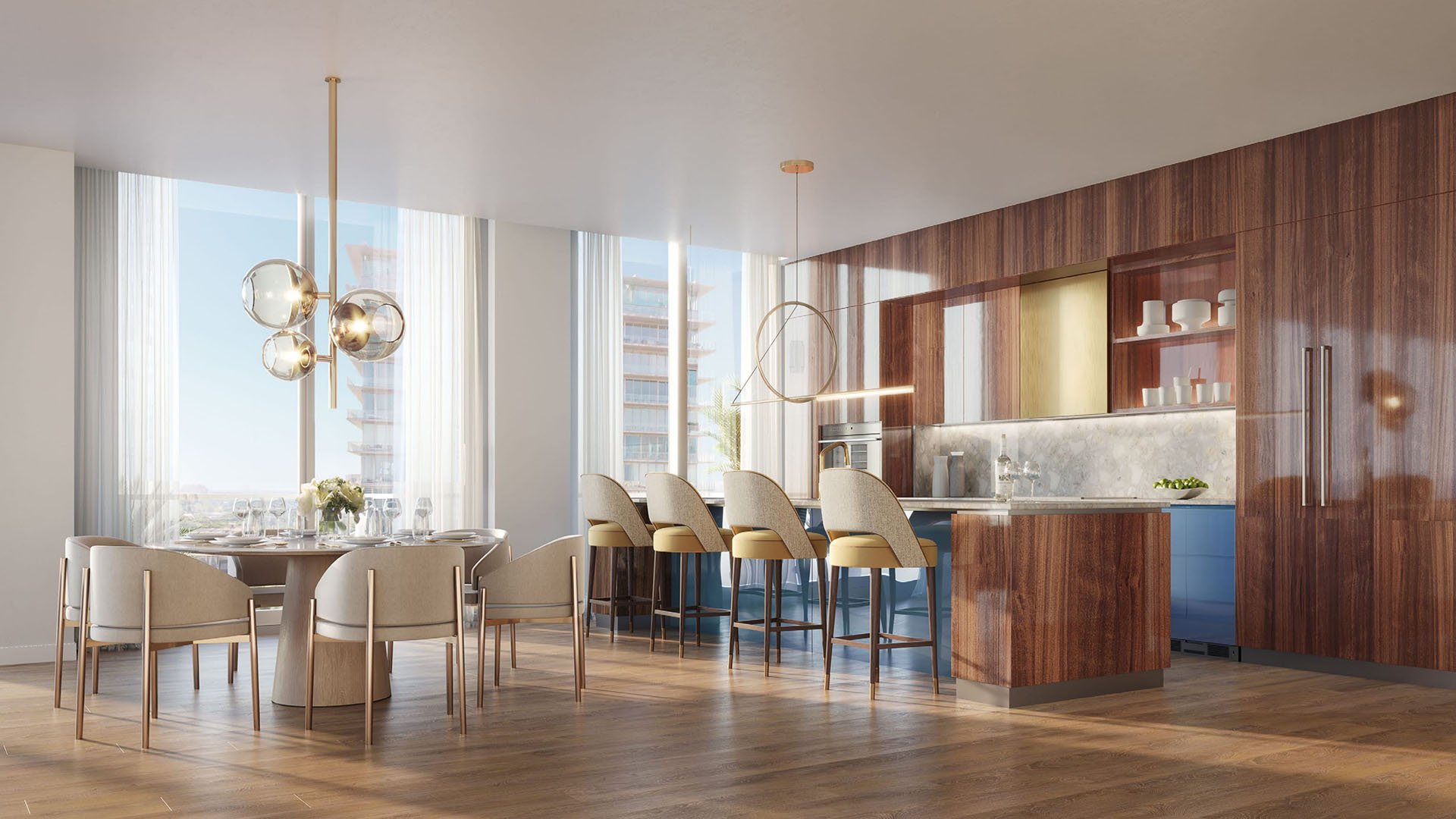 Wood-paneled chef kitchen with a blue island, bar seating, and round dining table at Mr C Residences Bayshore Tower in Coconut Grove, featuring luxury, ultra luxury condos with warm contemporary finishes.