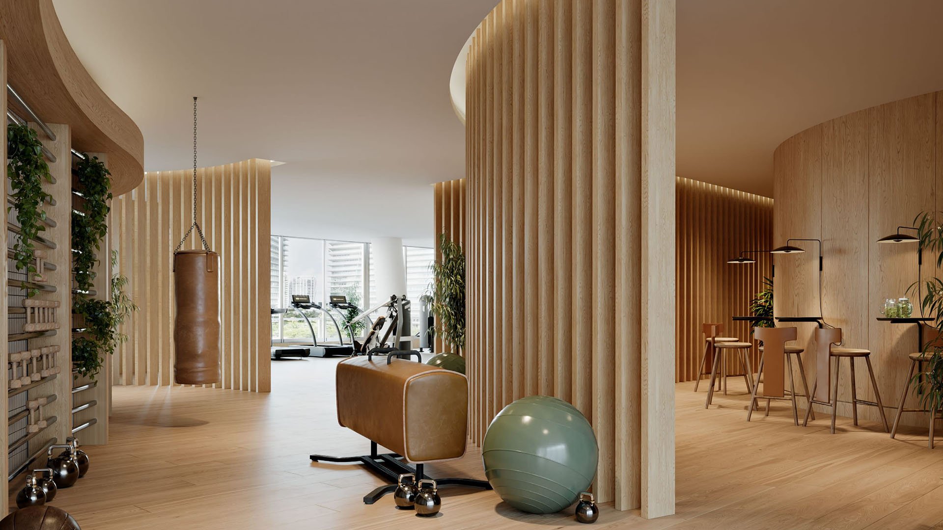 Fitness lounge with a boxing bag, stall bars, and casual wellness seating at Mr C Residences Bayshore Tower in Coconut Grove, highlighting luxury, ultra luxury condos with active lifestyle amenities.