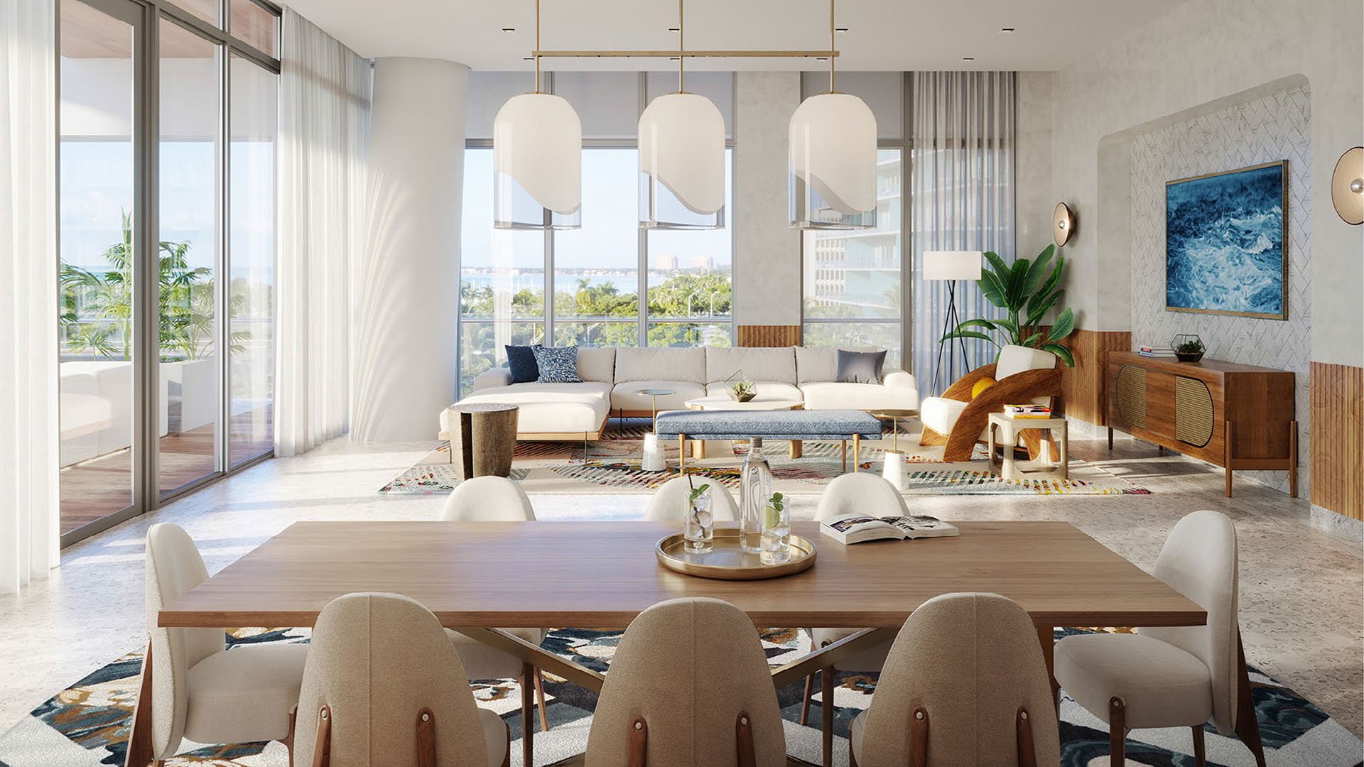 Great room with dining table, lounge seating, and full height glazing at Mr C Residences Bayshore Tower in Coconut Grove, showcasing luxury, ultra luxury condos with bright open interiors and leafy outlooks.