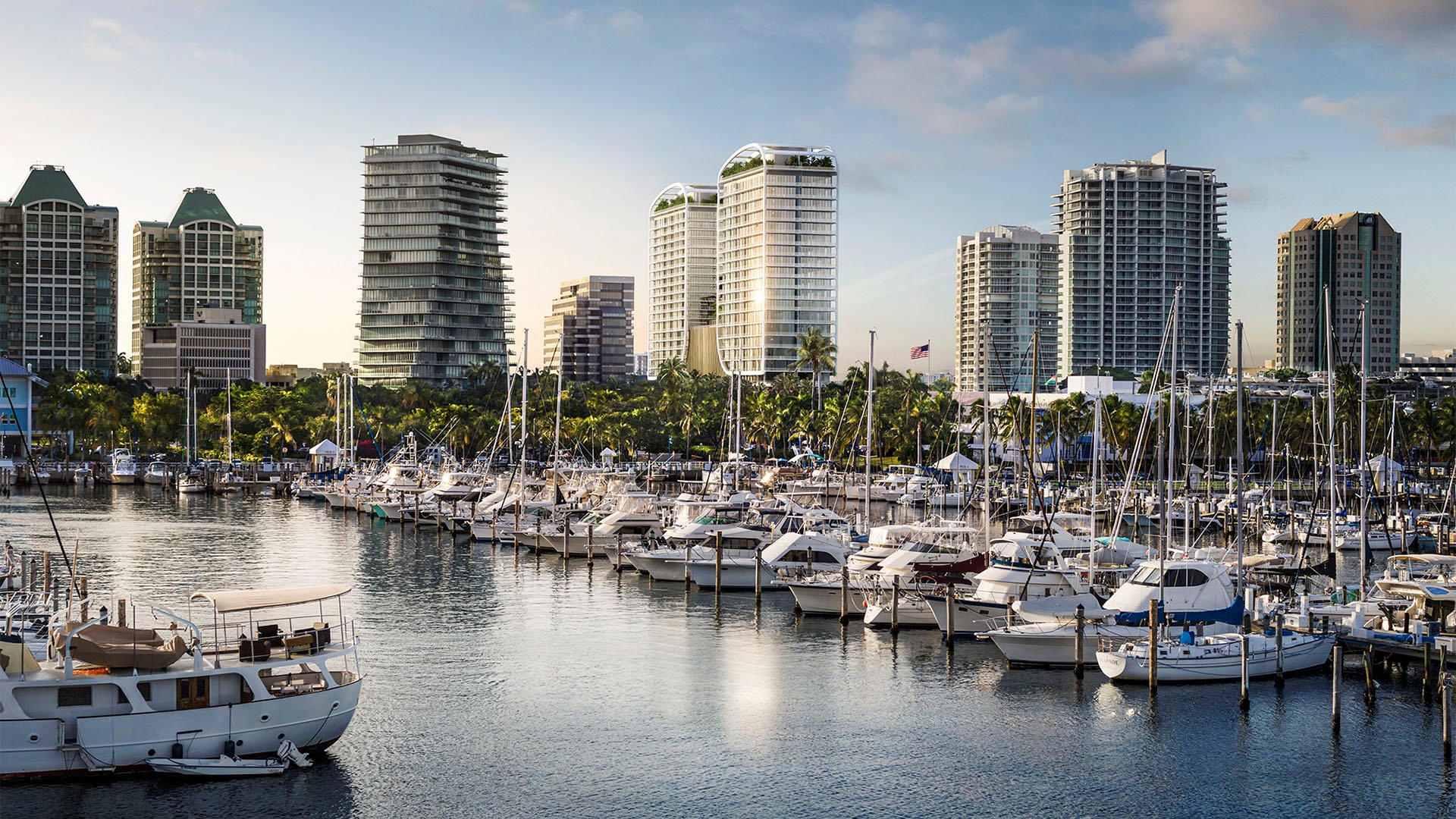 Waterfront marina view with boat slips and skyline towers near Mr C Residences Bayshore Tower in Coconut Grove, showcasing luxury, ultra luxury condos with a scenic boating oriented setting.
