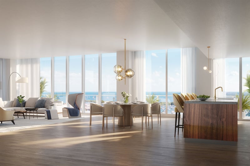 Open plan living, dining, and chef kitchen with floor-to-ceiling windows and bay views at Mr C Residences Bayshore Tower in Coconut Grove, presenting luxury, ultra luxury condos with bright waterfront interiors.