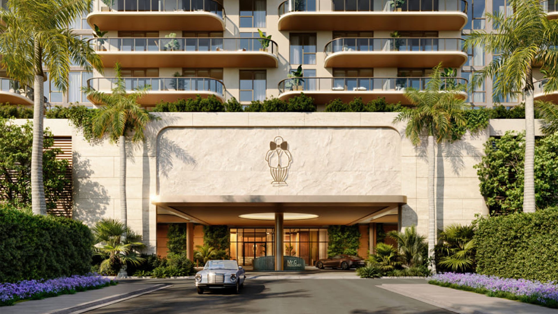 Preconstruction arrival porte cochere at Mr. C Residences in Boca Raton beneath curved balconies, with palms, lush landscaping, and a covered drop-off for luxury and ultra luxury condos.