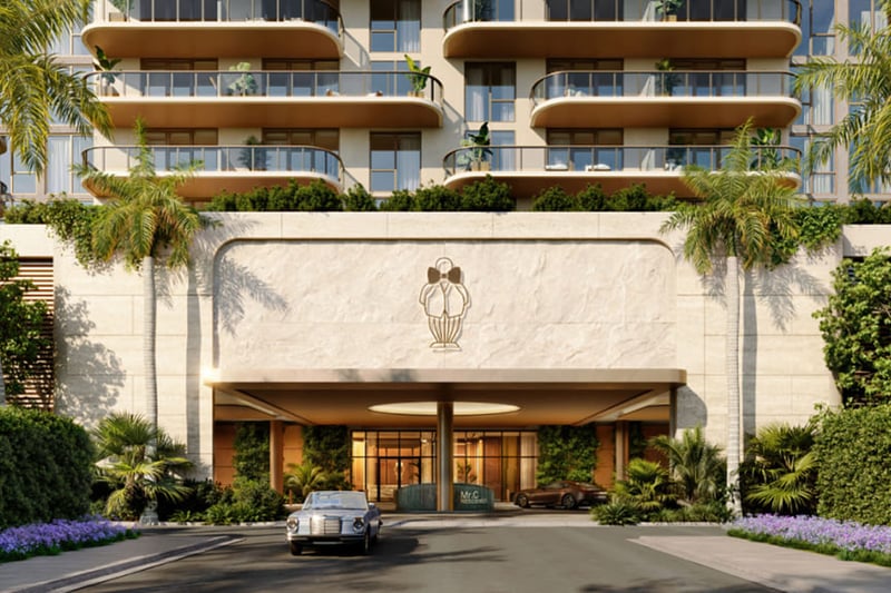 Preconstruction arrival porte cochere at Mr. C Residences in Boca Raton beneath curved balconies, with palms, lush landscaping, and a covered drop-off for luxury and ultra luxury condos.