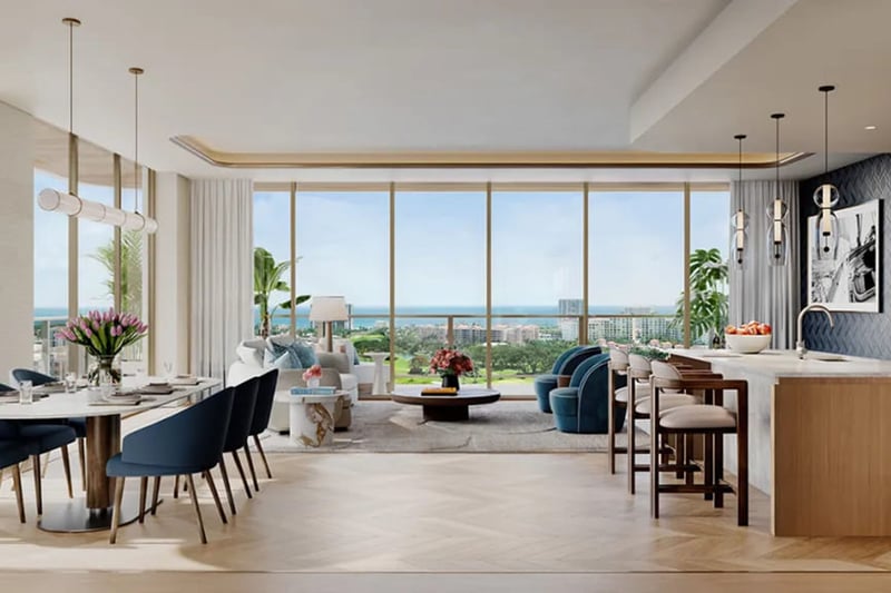 Open-concept chef kitchen, dining, and living room at Mr. C Residences in Boca Raton with floor-to-ceiling glass and ocean views, representing preconstruction luxury and ultra luxury condos.