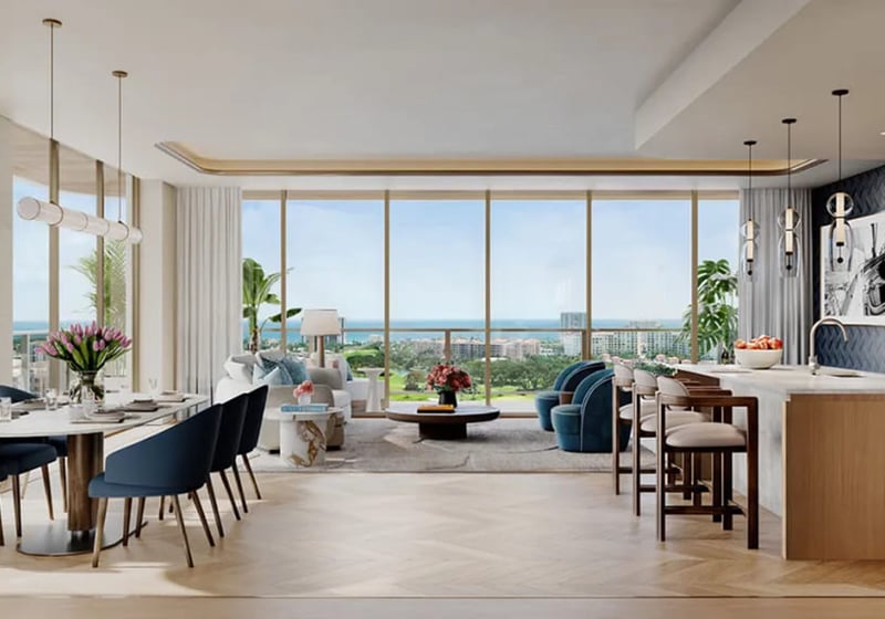 Open-concept chef kitchen, dining, and living room at Mr. C Residences in Boca Raton with floor-to-ceiling glass and ocean views, representing preconstruction luxury and ultra luxury condos.