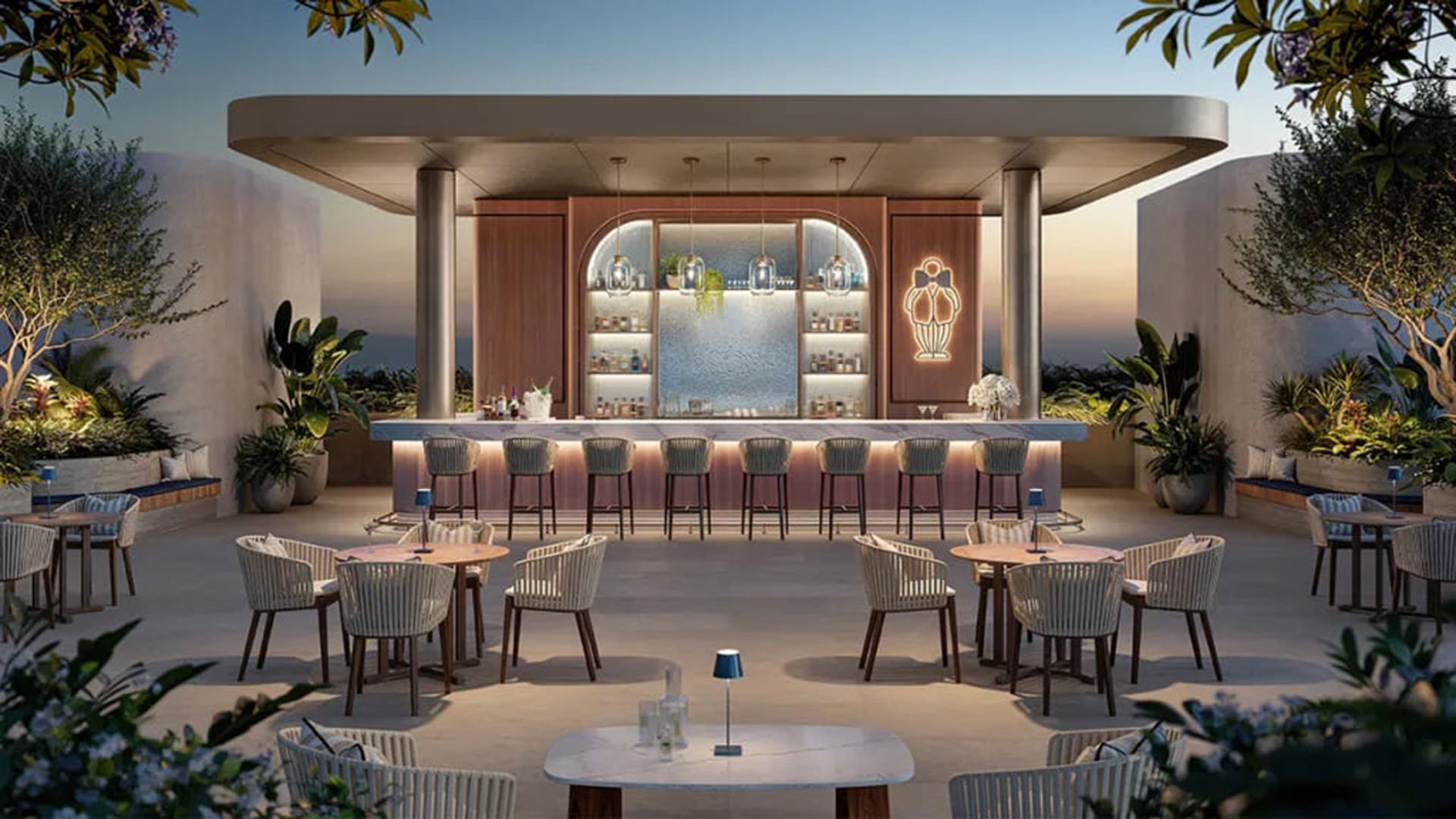 Outdoor bar pavilion at Mr. C Residences in Boca Raton with open-air cocktail seating, illuminated shelving, and landscaped lounge areas for preconstruction luxury and ultra luxury condos.