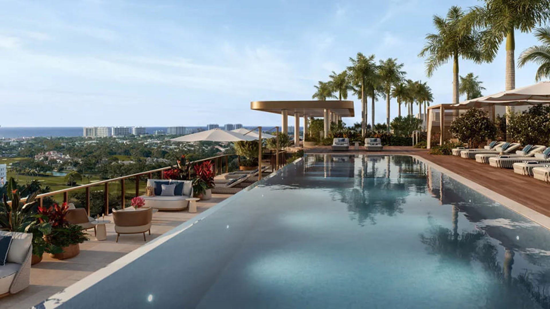 Rooftop pool terrace at Mr. C Residences in Boca Raton with palm trees, pergola seating, and ocean horizon views, showcasing amenities for preconstruction luxury and ultra luxury condos.