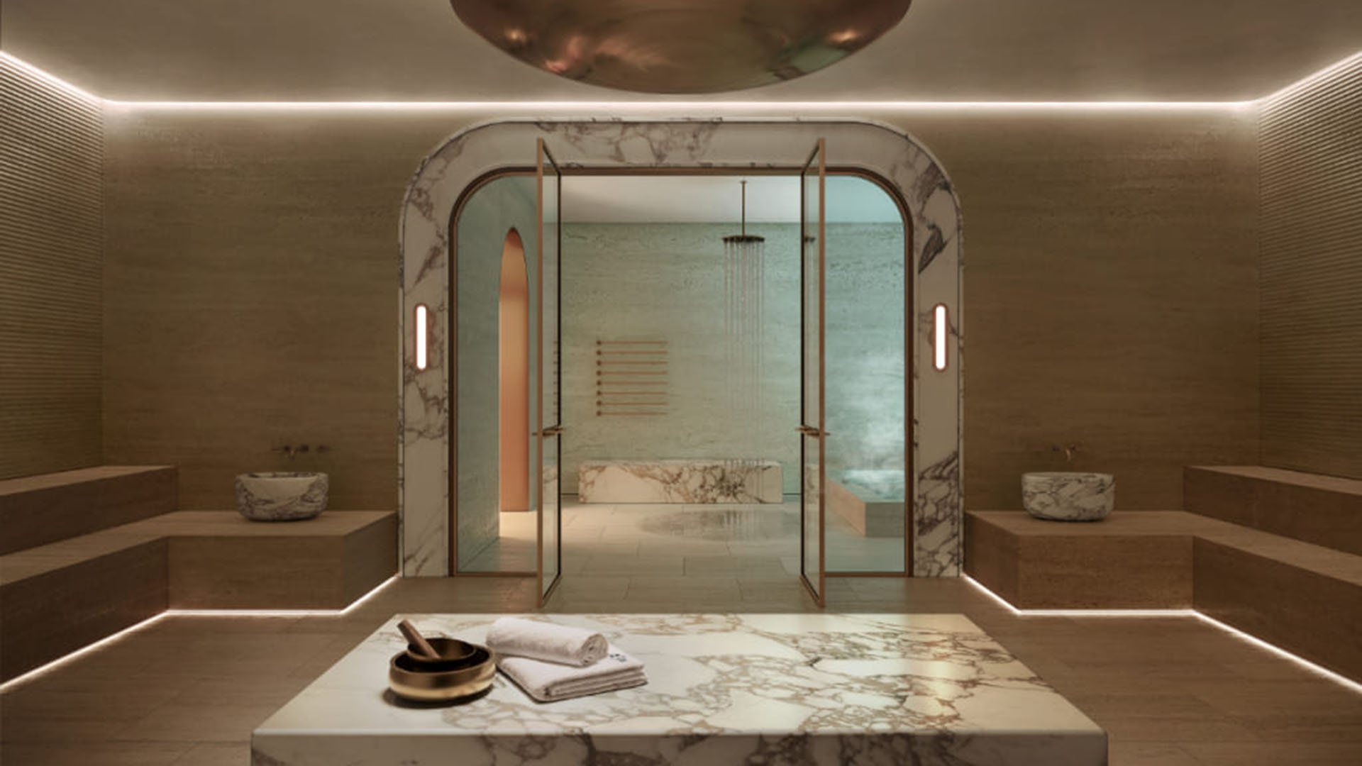 Spa steam room at Mr. C Residences in Boca Raton with marble benches, glass doors, and warm ambient lighting, reflecting amenities for preconstruction luxury and ultra luxury condos.