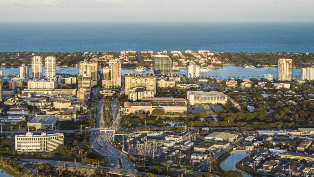 Mr. C Residences West Palm Beach aerial coastal waterfront view, featuring luxury and ultra luxury preconstruction condos near the cityscape.