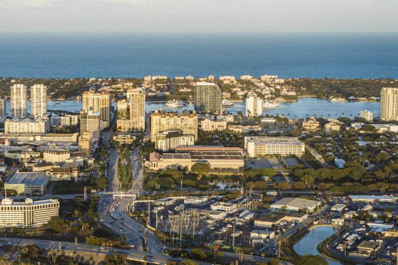 Mr. C Residences West Palm Beach aerial coastal waterfront view, featuring luxury and ultra luxury preconstruction condos near the cityscape.