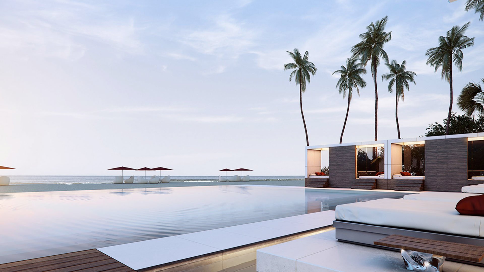 Infinity pool terrace with palm trees, loungers, and waterfront cabanas at Muse Residences in Sunny Isles Beach, complementing luxury and ultra luxury condos.