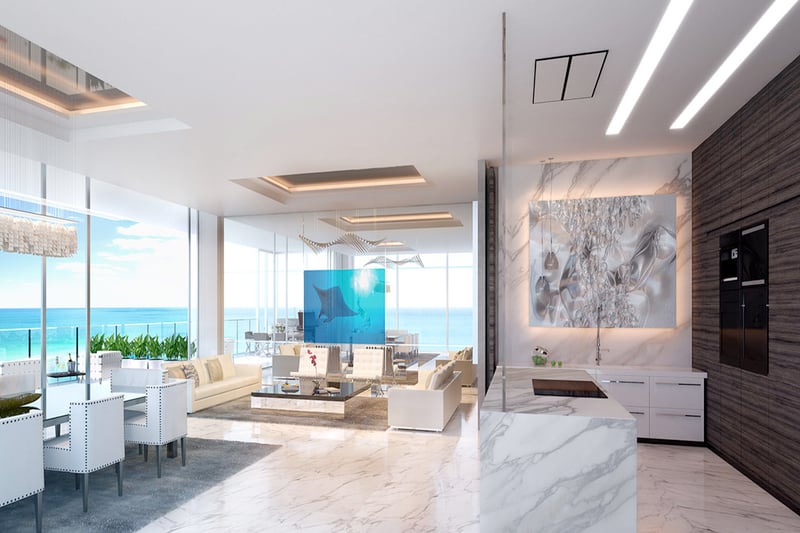 Open oceanview great room with dining, marble finishes, and a blue art divider at Muse Residences in Sunny Isles Beach, styled for luxury and ultra luxury condos.