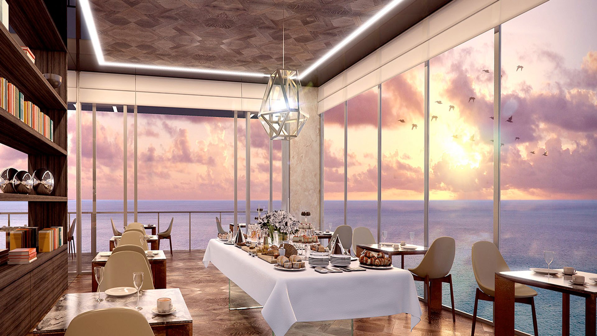 Sunrise breakfast room with oceanfront dining and floor-to-ceiling glass at Muse Residences in Sunny Isles Beach, tailored to luxury and ultra luxury condos.