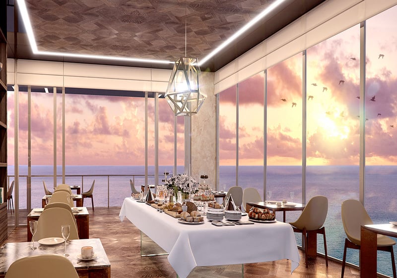 Sunrise breakfast room with oceanfront dining and floor-to-ceiling glass at Muse Residences in Sunny Isles Beach, tailored to luxury and ultra luxury condos.