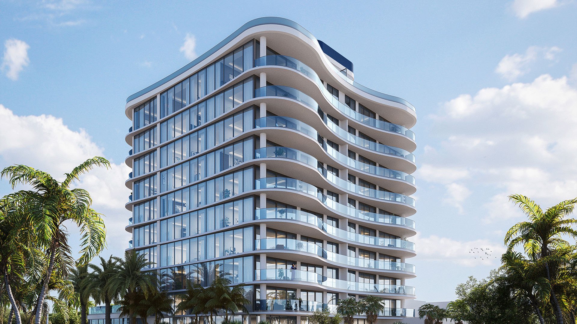 Exterior view of Ocean 580 in Pompano Beach, preconstruction luxury and ultra luxury condos with a curved glass facade, wraparound balconies, palm trees and a bright coastal sky.