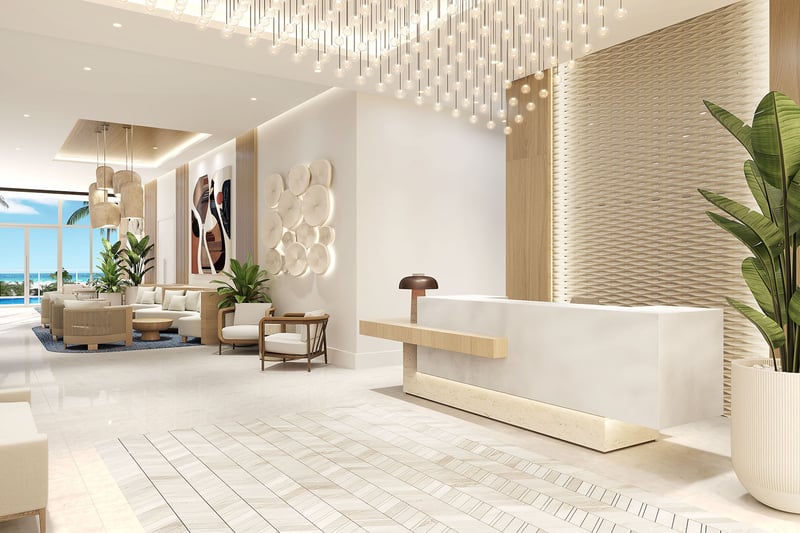 Lobby reception at Ocean 580 in Pompano Beach, preconstruction luxury and ultra luxury condos with a sleek reception desk, designer seating, statement lighting, textured walls and ocean-facing windows.