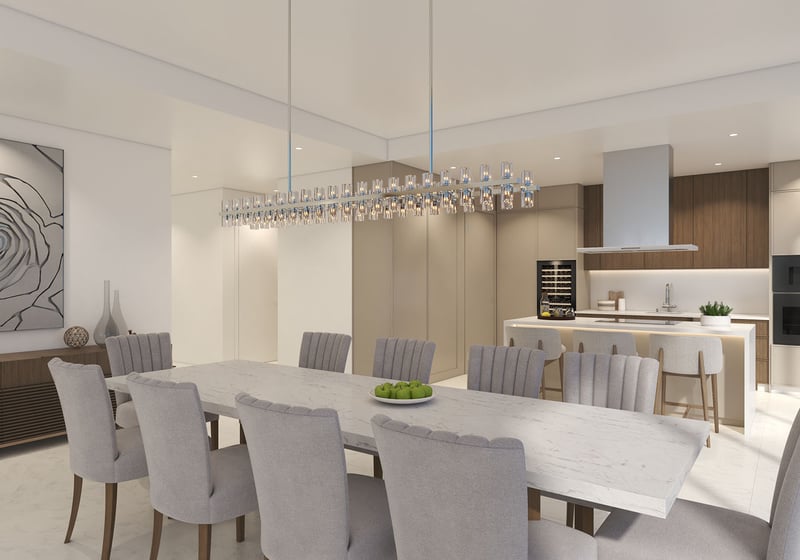 Open-concept chef kitchen and dining room at Ocean 580 in Pompano Beach, preconstruction luxury and ultra luxury condos with a marble dining table, island seating, built-in appliances and a wine fridge.