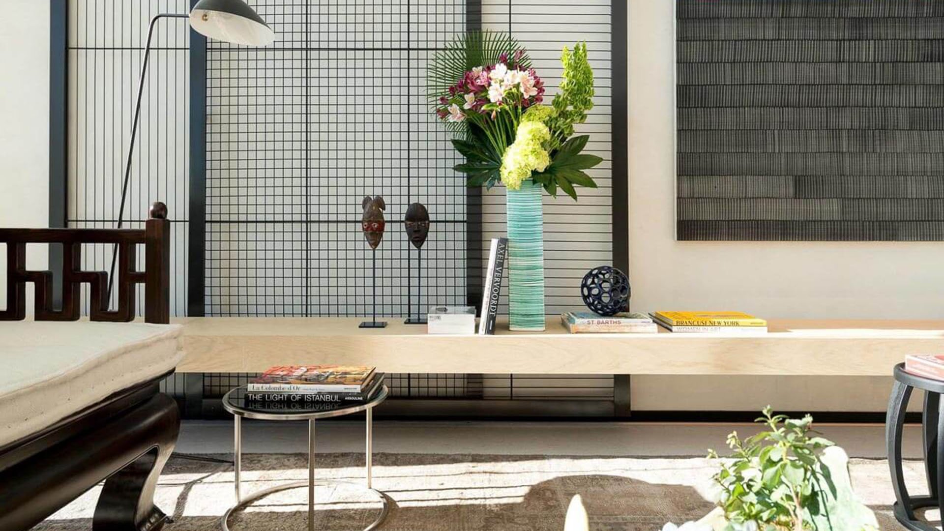 Designer lobby vignette with a console bench, floral arrangement and textured art wall at Oceana Bal Harbour in Bal Harbour, Florida, expressing the luxury arrival experience of these ultra luxury condos.