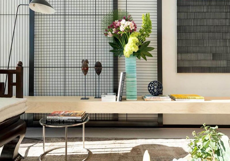 Designer lobby vignette with a console bench, floral arrangement and textured art wall at Oceana Bal Harbour in Bal Harbour, Florida, expressing the luxury arrival experience of these ultra luxury condos.